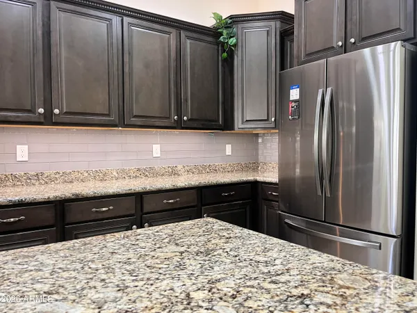 a view of a dining room with a table and chairs