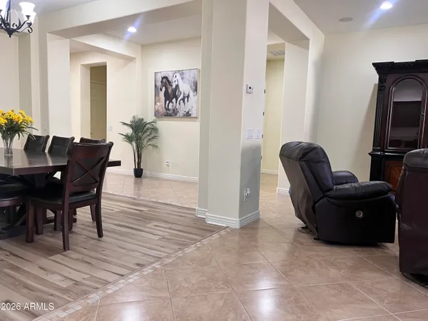 a view of a dining room with furniture wooden floor and chandelier