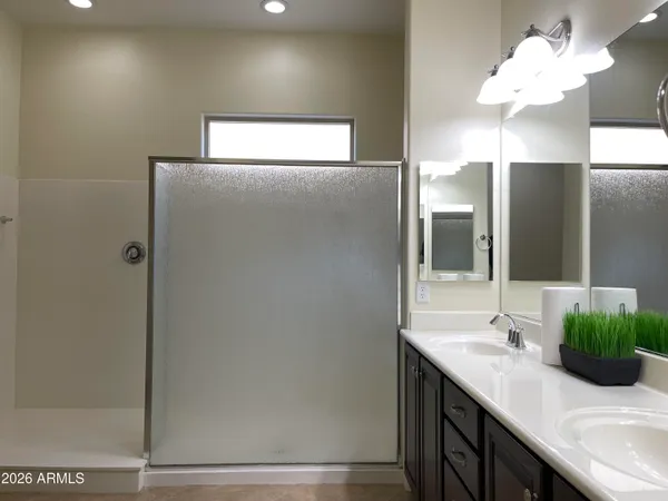 a bathroom with a glass shower door