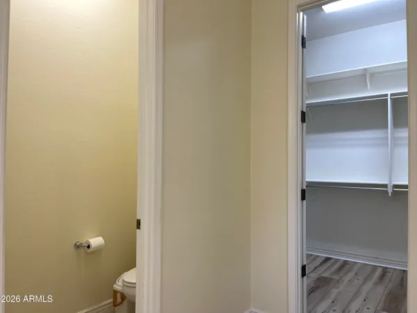 a view of a room with wooden floor and fan
