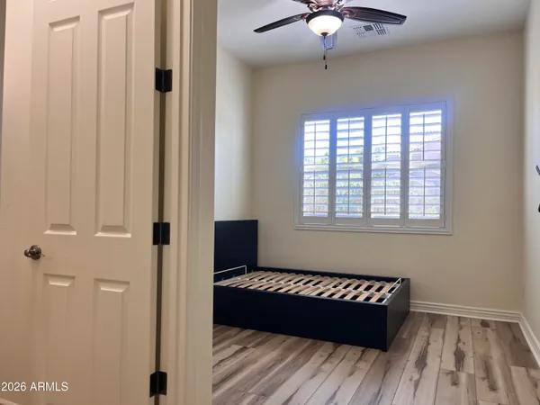 a room with a bed and a ceiling fan