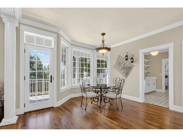 a view of a livingroom with furniture wooden floor and chandelier