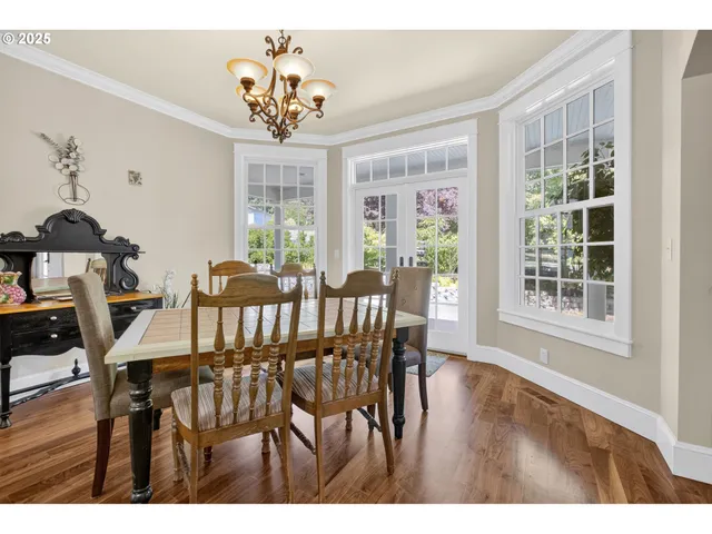 a view of a dining room with furniture wooden floor and chandelier