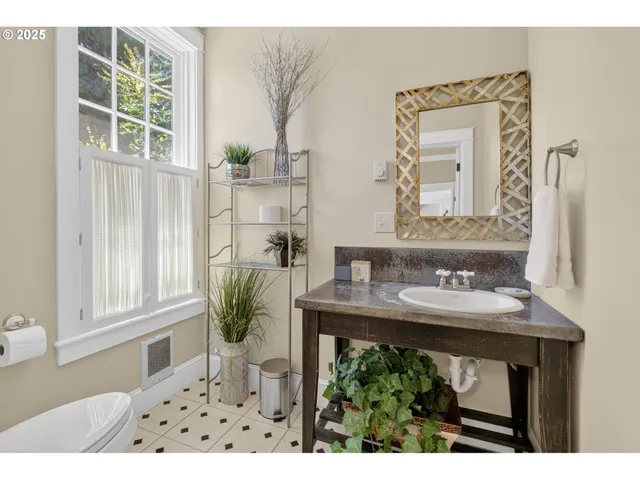 a bathroom with a sink a mirror and a window