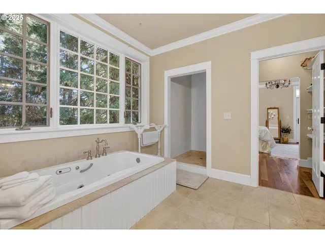 a bathroom with a tub sink and mirror