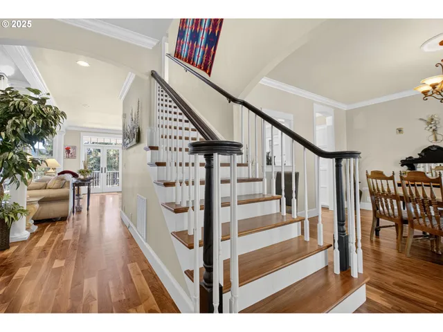 a view of entryway livingroom and hall with wooden floor