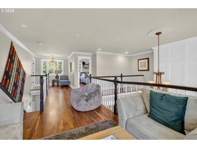 a living room with furniture wooden floor and a flat screen tv