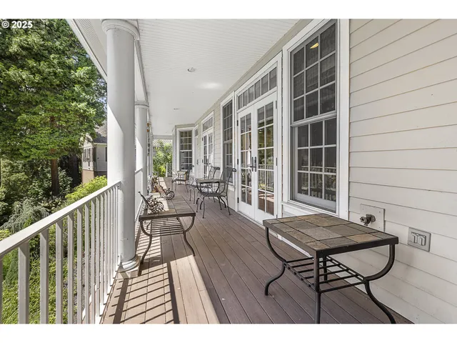 a view of balcony with wooden floor and seating space