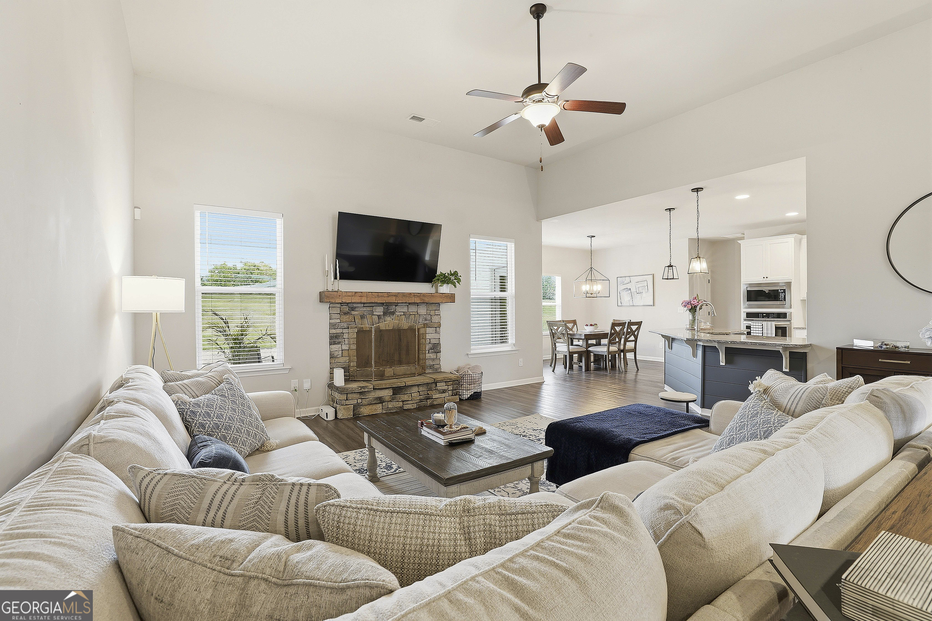 66 Chapman Farm Road Senoia, GA 30276 - Photo 16 of 46 a living room with furniture a fireplace and a flat screen tv