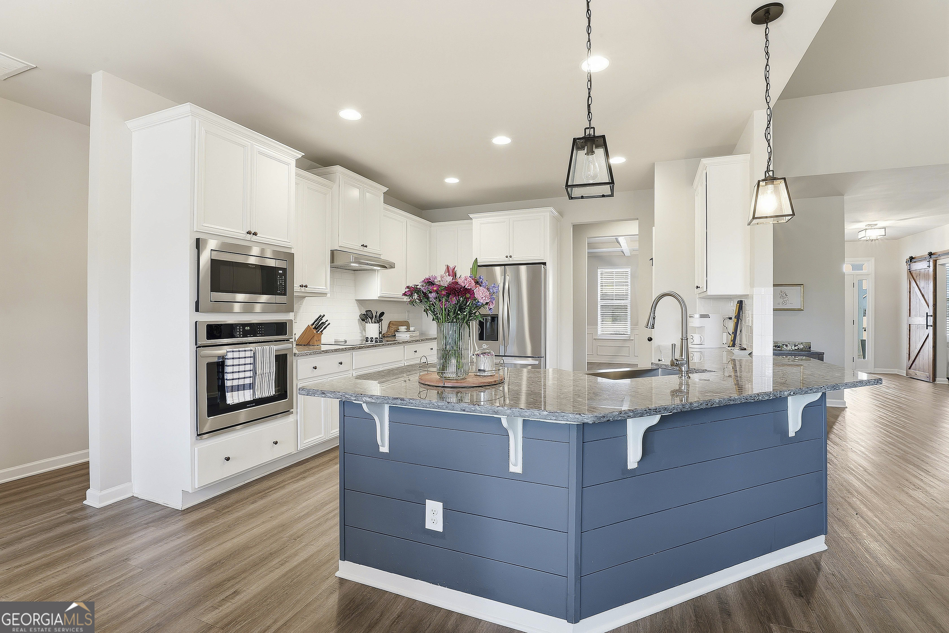 66 Chapman Farm Road Senoia, GA 30276 - Photo 20 of 46 a kitchen with stainless steel appliances granite countertop a sink and cabinets