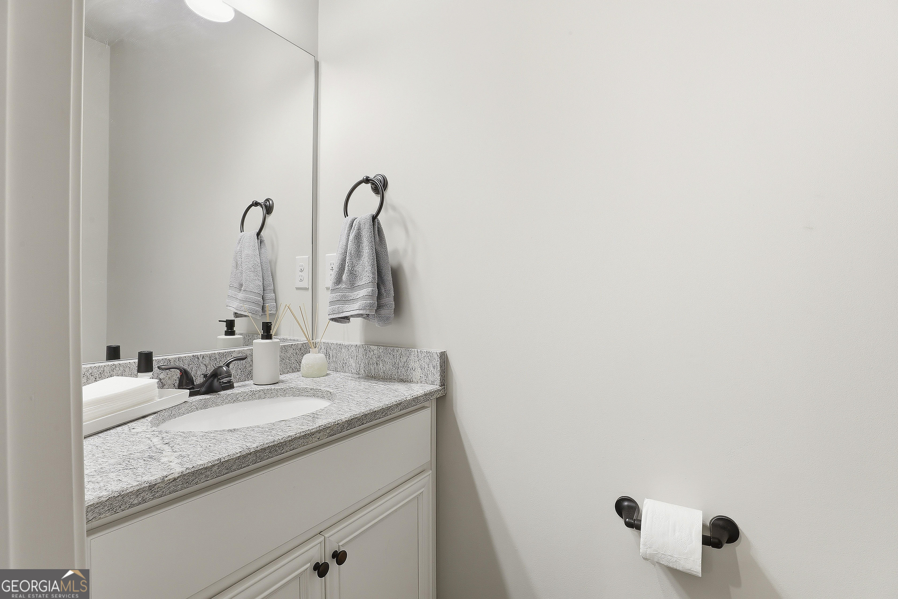66 Chapman Farm Road Senoia, GA 30276 - Photo 23 of 46 a bathroom with a granite countertop sink and a mirror