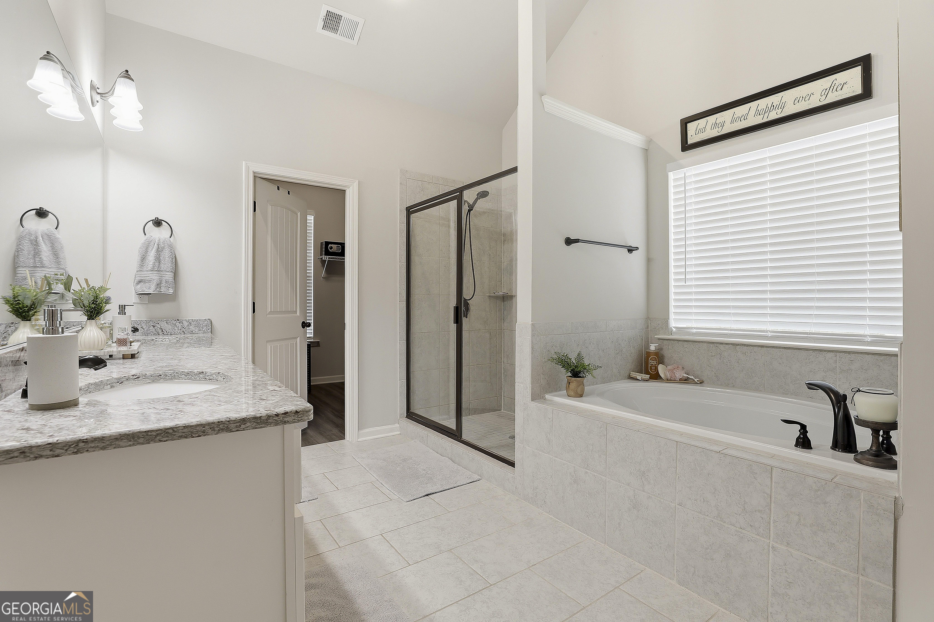 66 Chapman Farm Road Senoia, GA 30276 - Photo 27 of 46 a bathroom with a granite countertop sink and a mirror