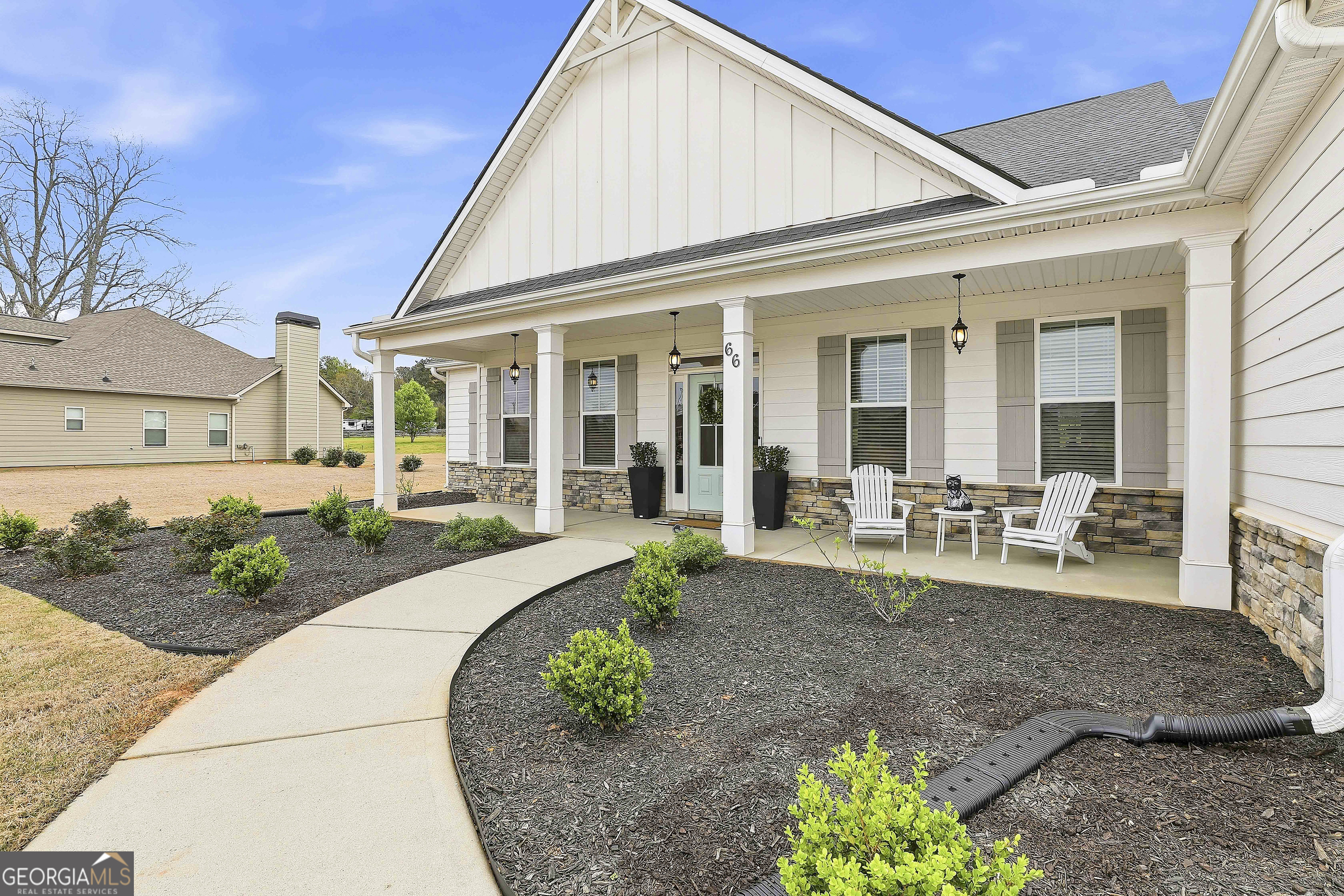 66 Chapman Farm Road Senoia, GA 30276 - Photo 3 of 46 a front view of a house with garden