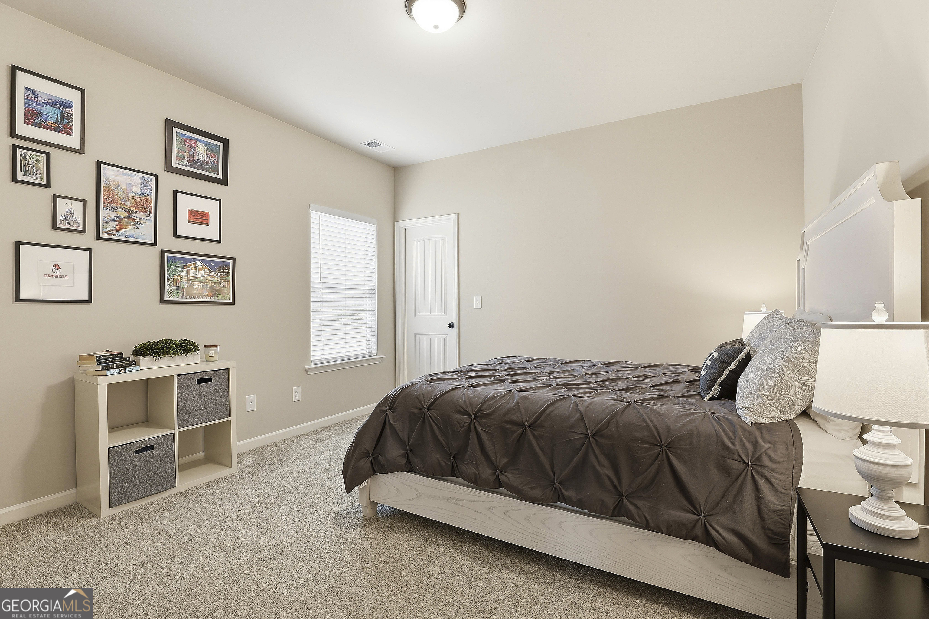 66 Chapman Farm Road Senoia, GA 30276 - Photo 31 of 46 a bedroom with a bed and cabinets