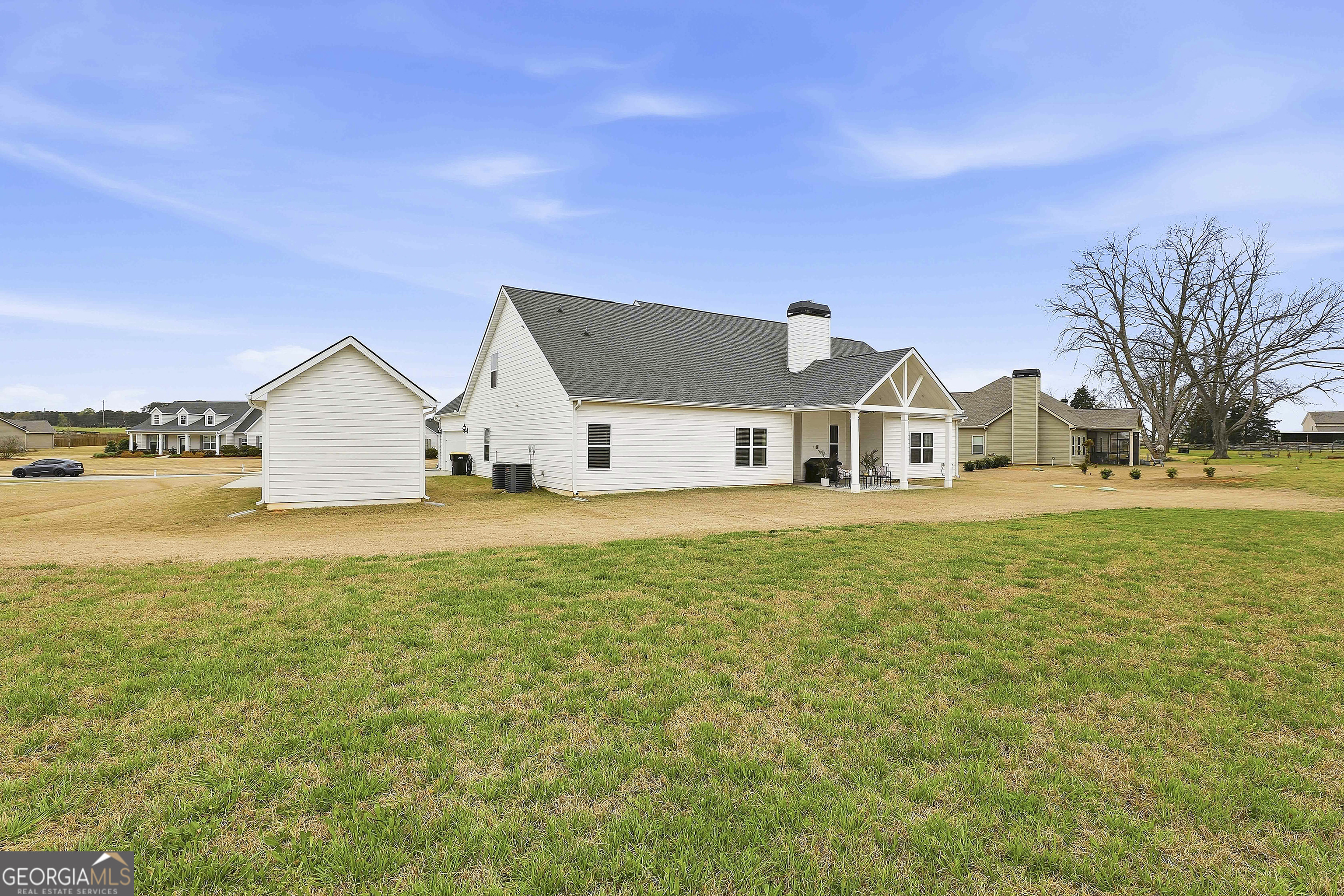 66 Chapman Farm Road Senoia, GA 30276 - Photo 40 of 46 a view of house with garden and tall trees