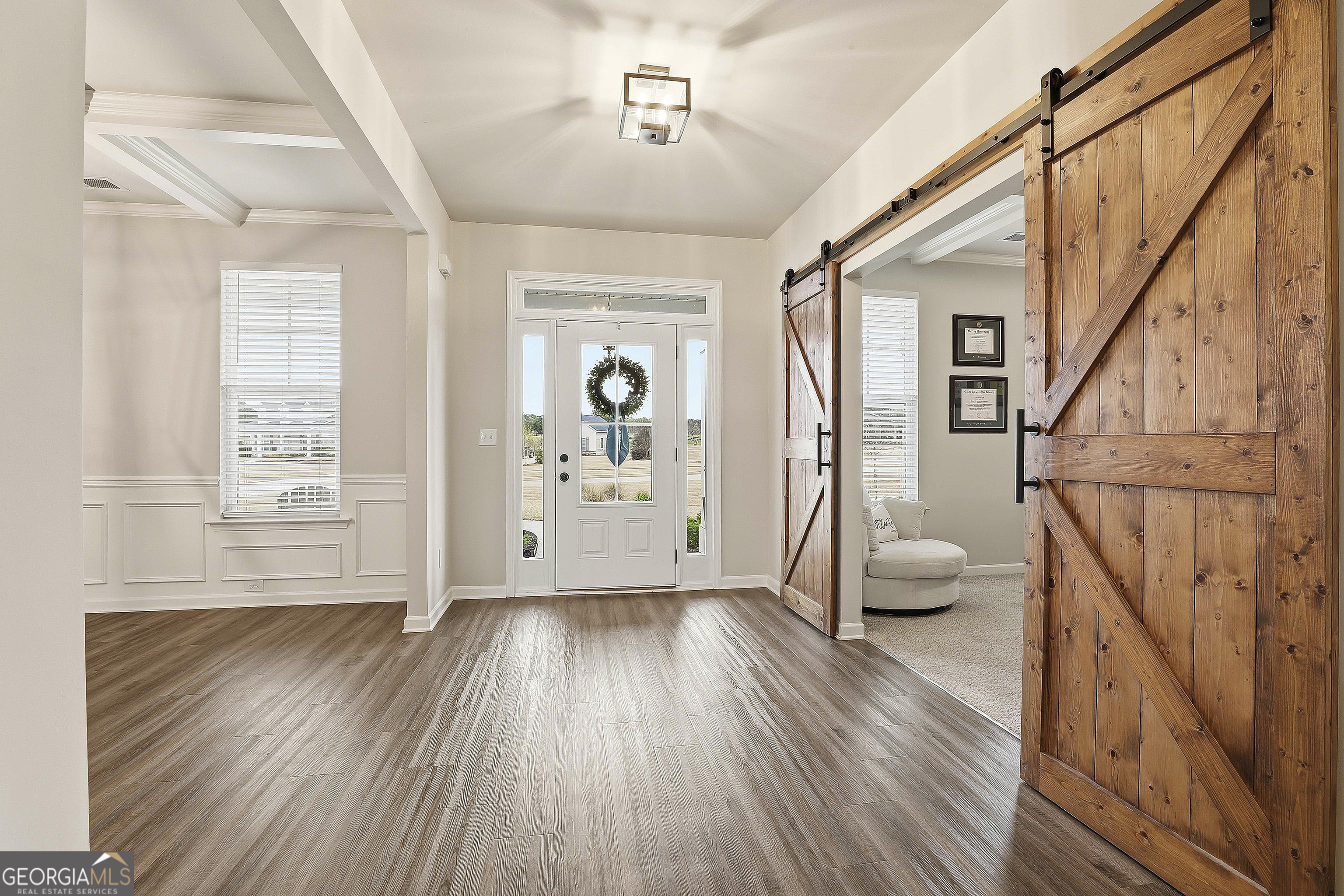 66 Chapman Farm Road Senoia, GA 30276 - Photo 6 of 46 a view of an empty room with wooden floor and a window