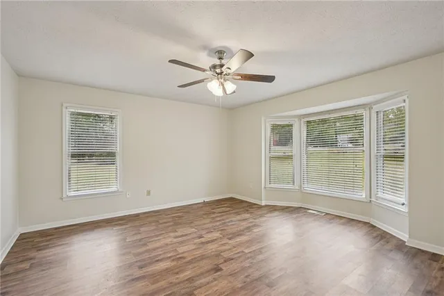 a view of a room with wooden floor and a window