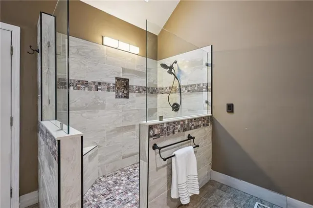 a view of a room with wooden floor and a bathroom