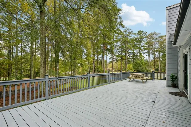 a view of a patio with table and chairs under an umbrella