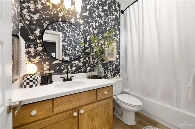 a bathroom with a sink toilet and shower