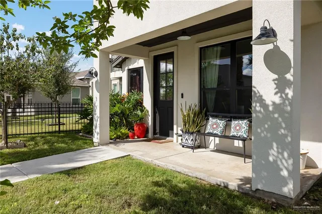 a view of a chair and table in backyard of the house