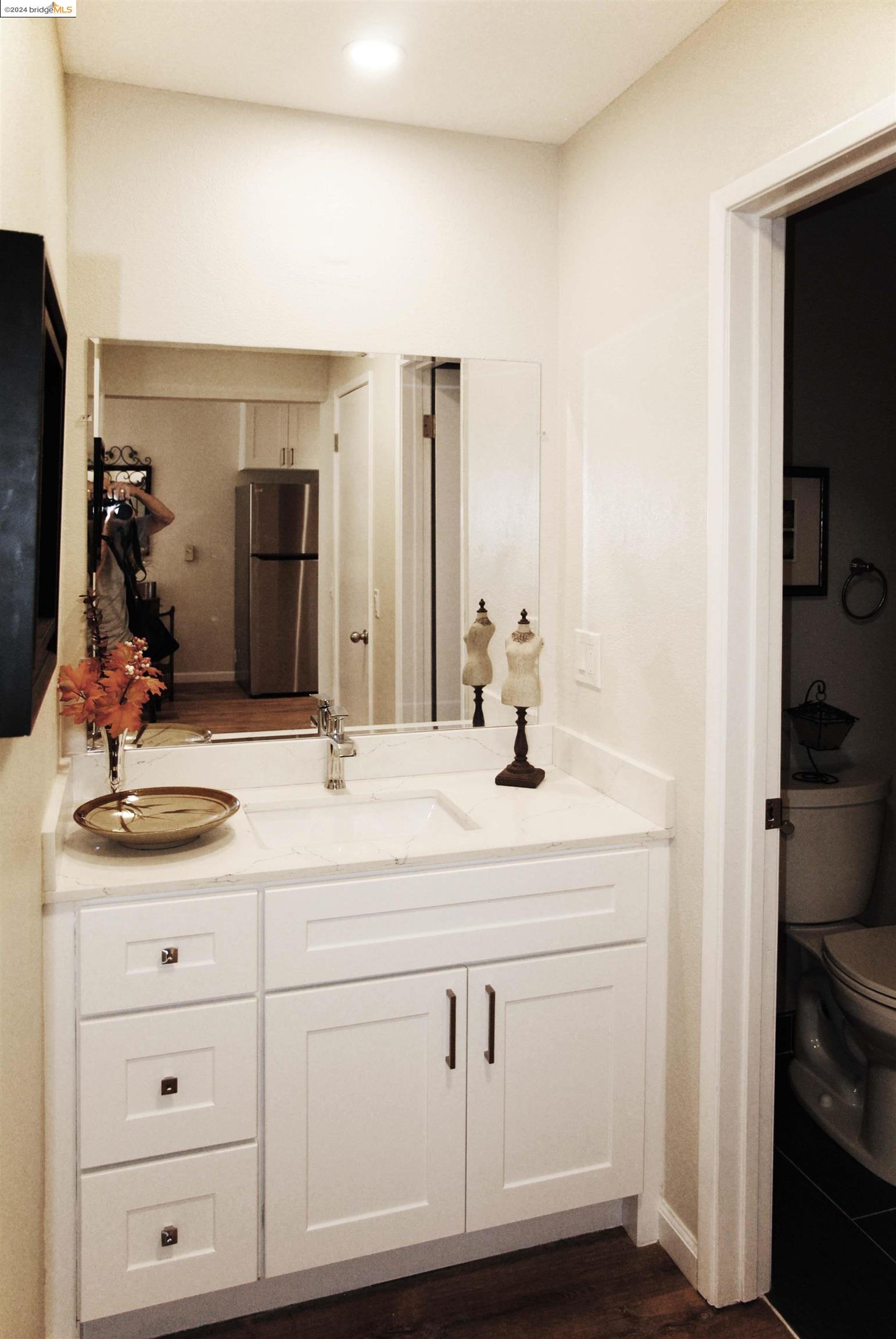 625 Madison Street, Unit 107 Oakland, CA 94607 - Photo 2 of 13 a bathroom with a sink and a mirror