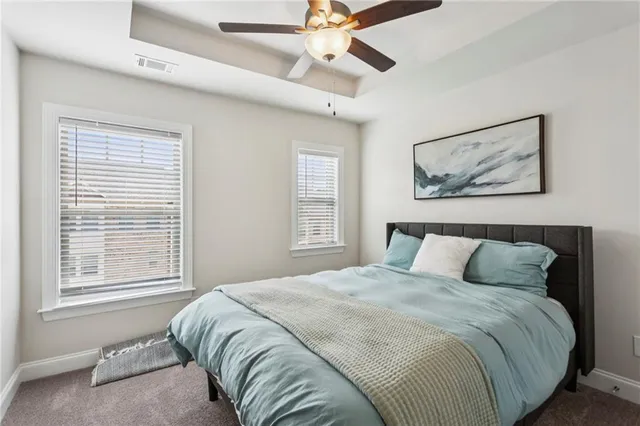 a bedroom with a large bed and a window