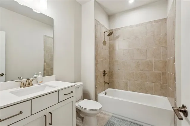 a bathroom with a sink a toilet a mirror a bathtub and shower