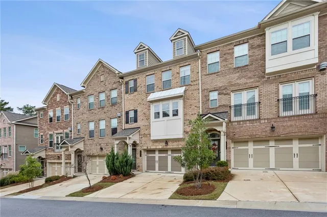 a front view of a residential apartment building with a yard