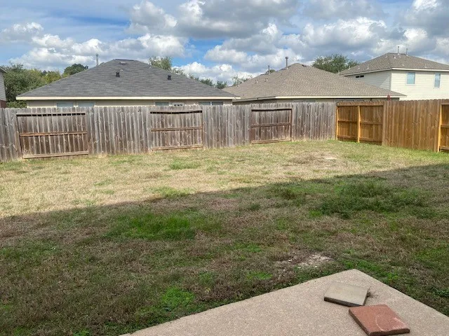 a view of a house with backyard and porch