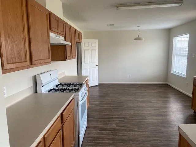 a kitchen with granite countertop a stove and a sink