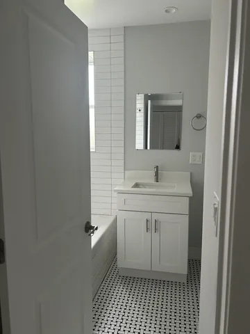 a bathroom with a sink a toilet and a mirror