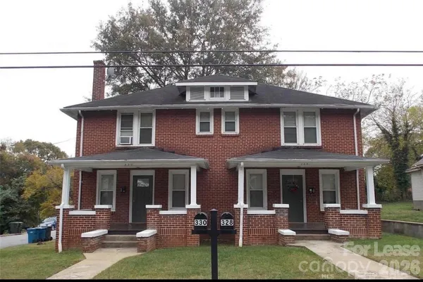 a front view of a house with a yard table and chairs