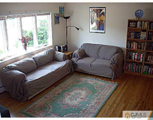 33 Finley Road Edison, NJ 08817 - Photo 3 of 10 a living room with furniture and a book shelf