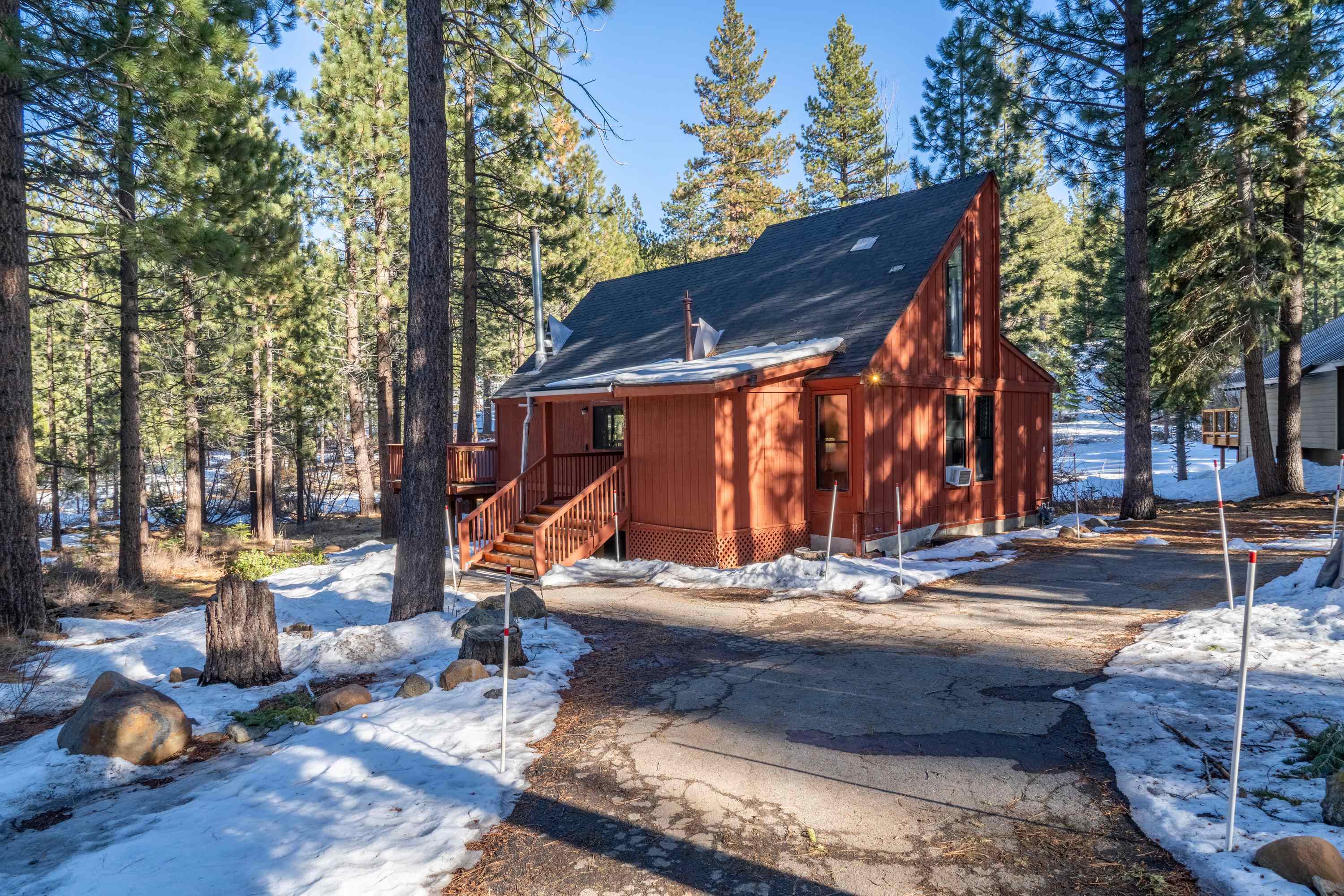842 Beaver Pond Truckee, CA 96161 - Photo 2 of 22 a view of a house with cars park fire pit and a large tree