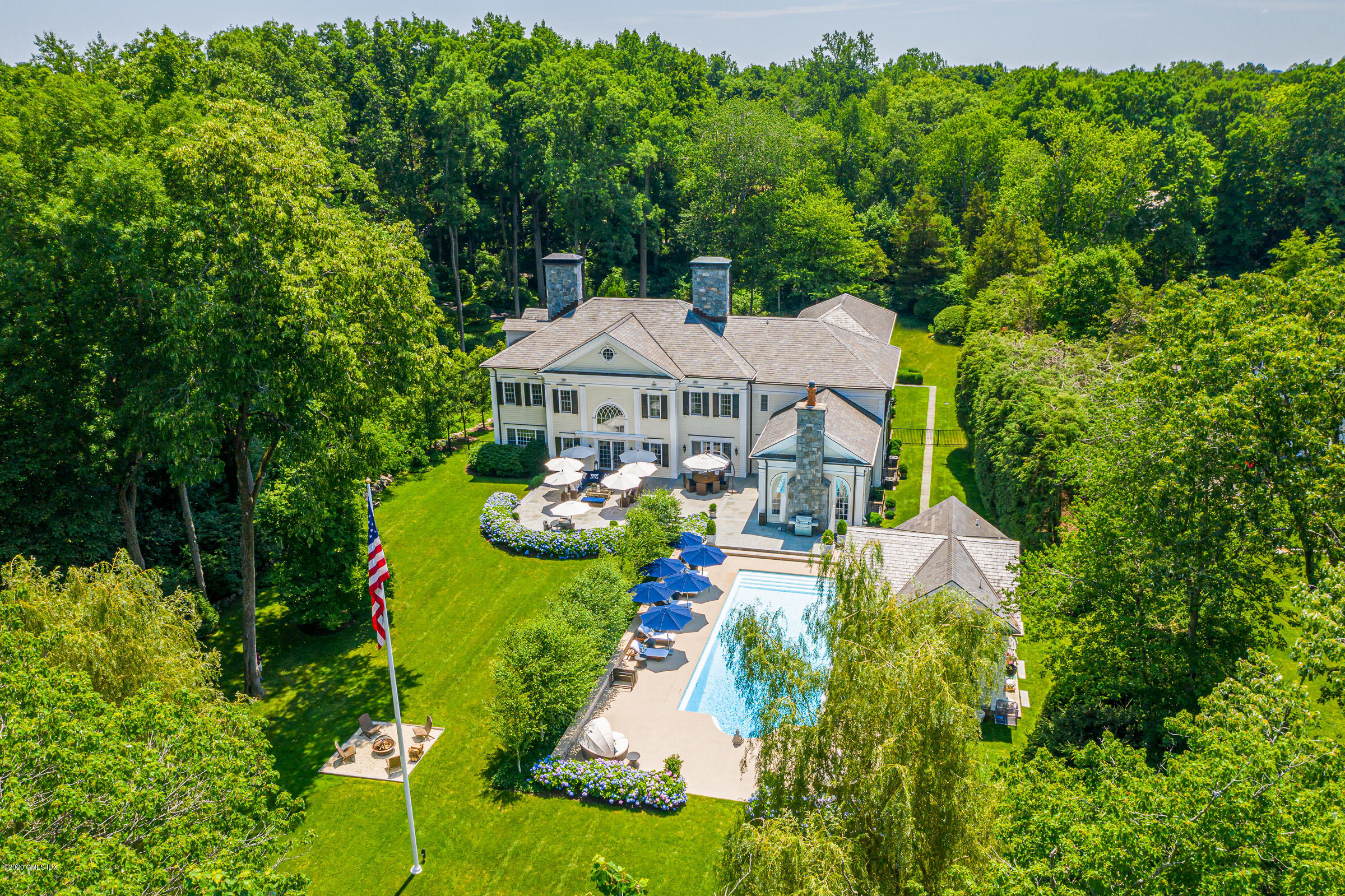 an aerial view of a house with a garden and swimming pool
