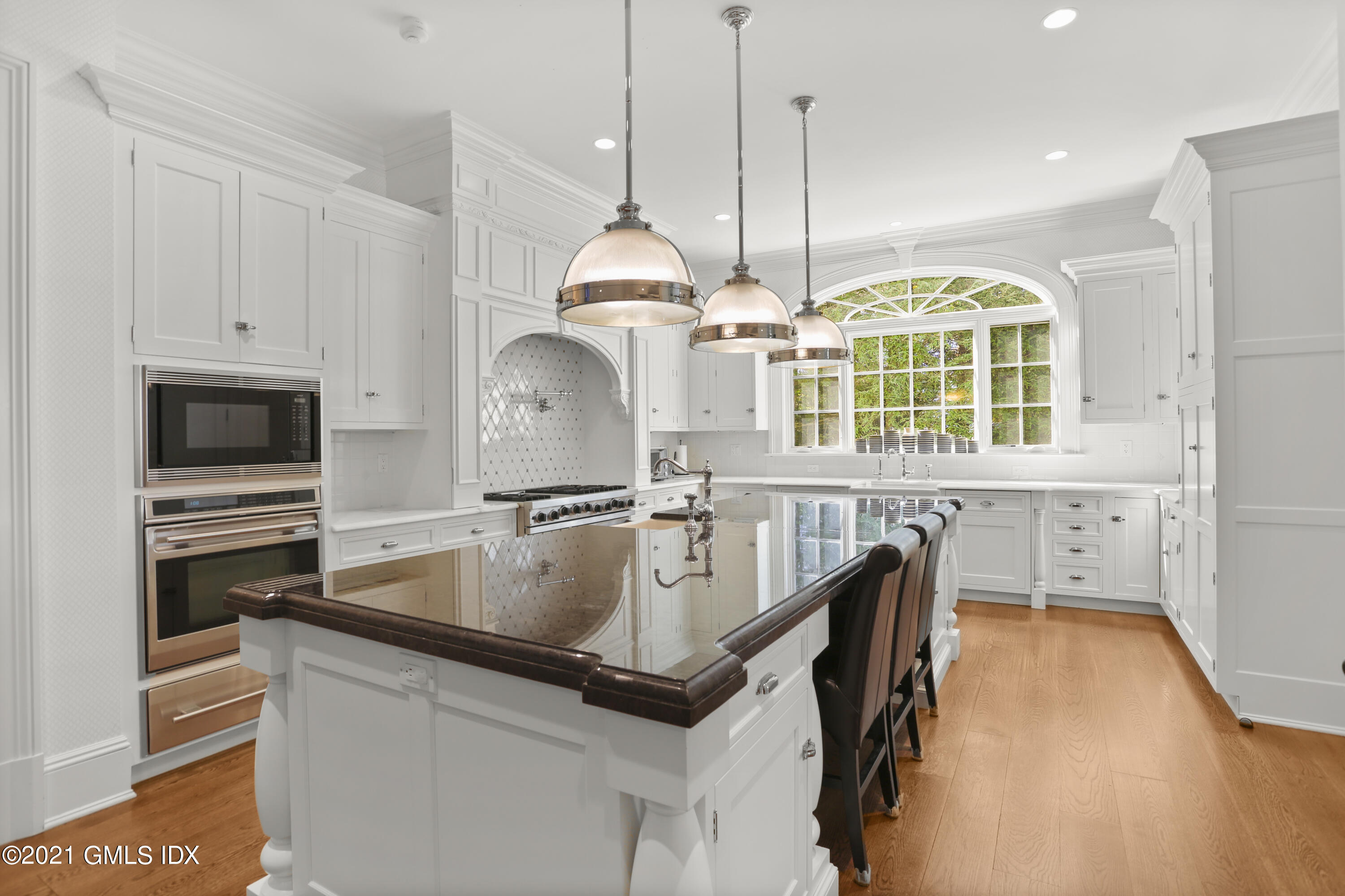 55 Perkins Road Greenwich, CT 06830 - Photo 17 of 38 a kitchen with center island a sink appliances and cabinets