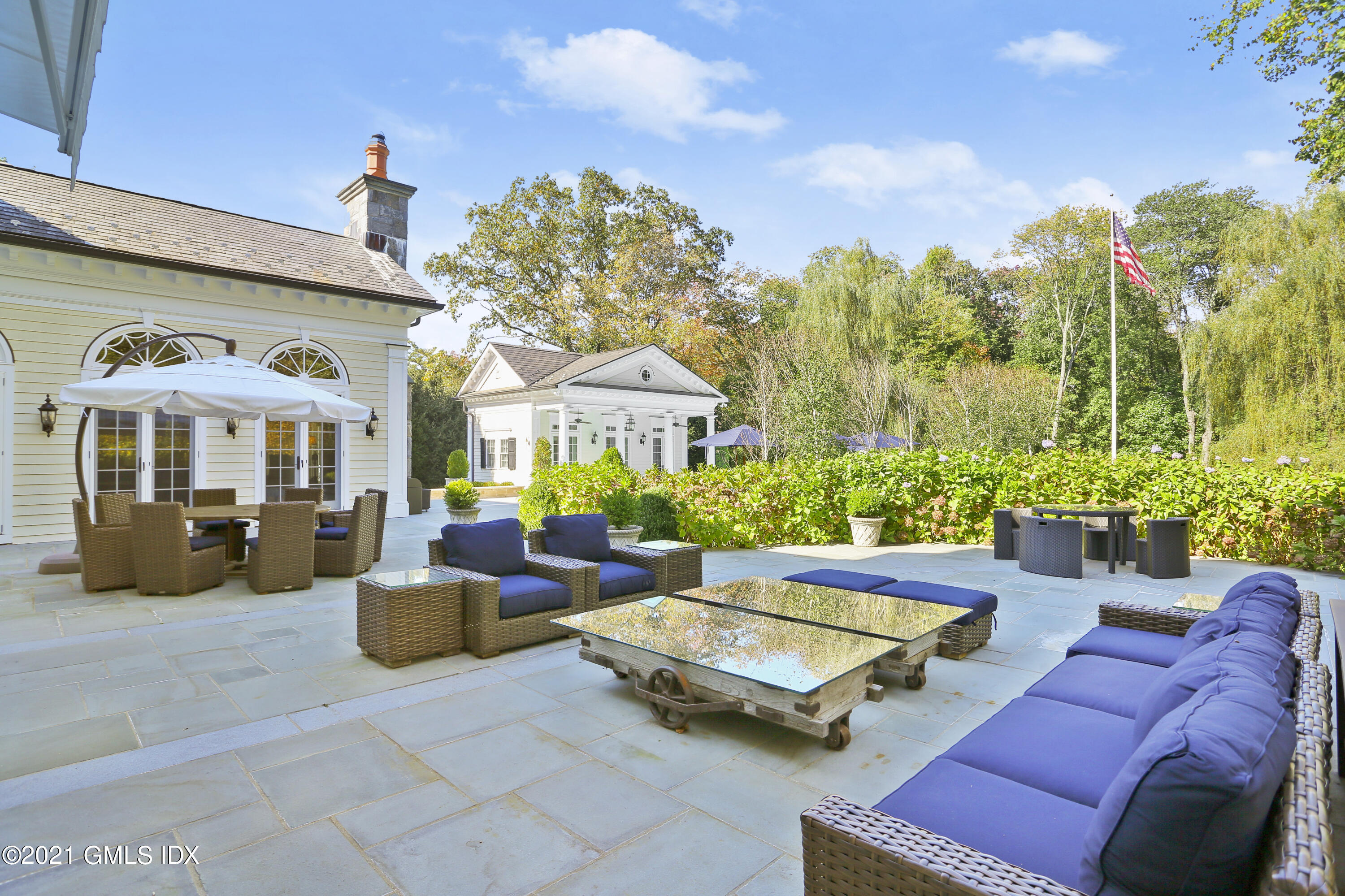 55 Perkins Road Greenwich, CT 06830 - Photo 28 of 38 a view of a patio with couches chairs and potted plants