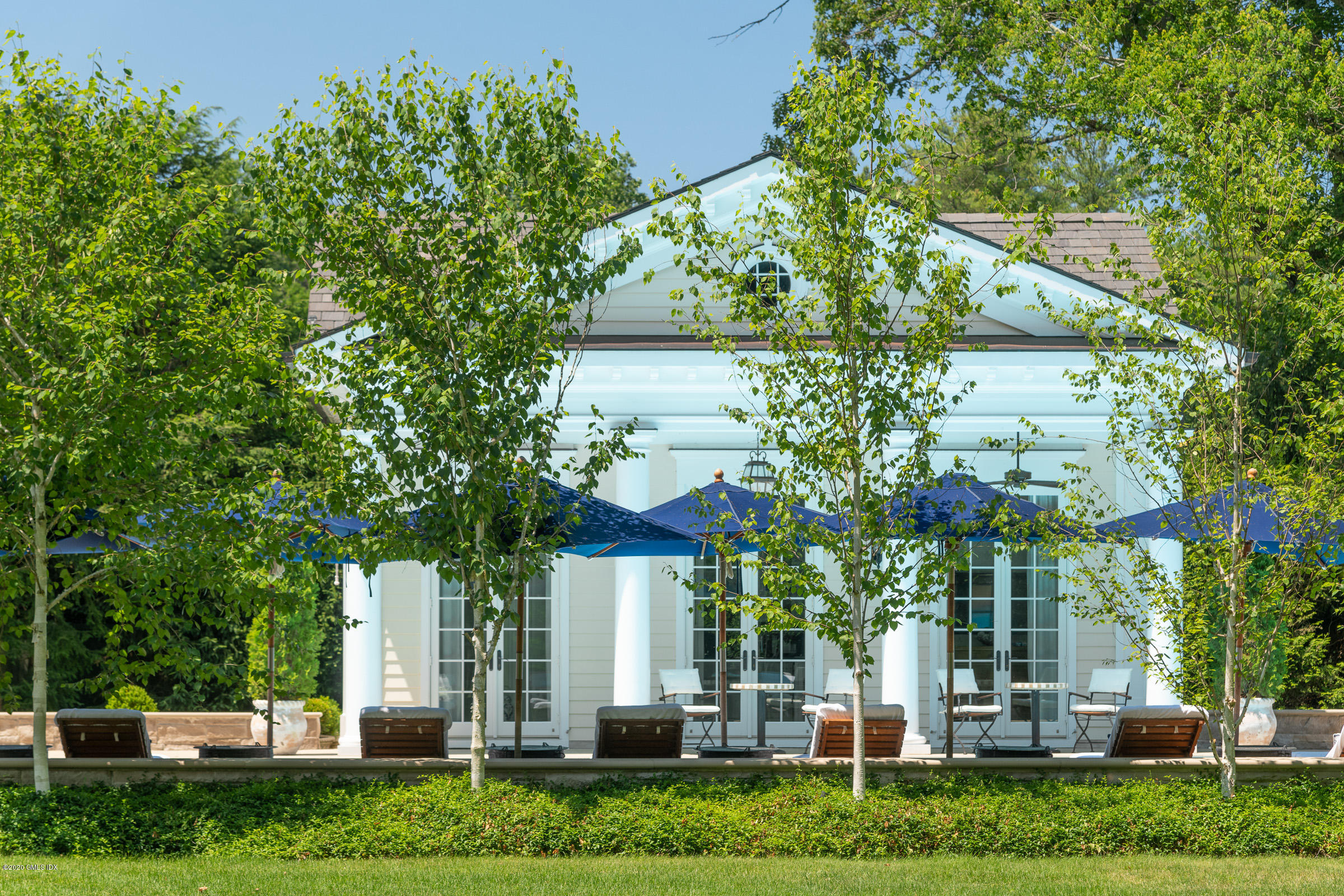 55 Perkins Road Greenwich, CT 06830 - Photo 30 of 38 a front view of a house with a tree