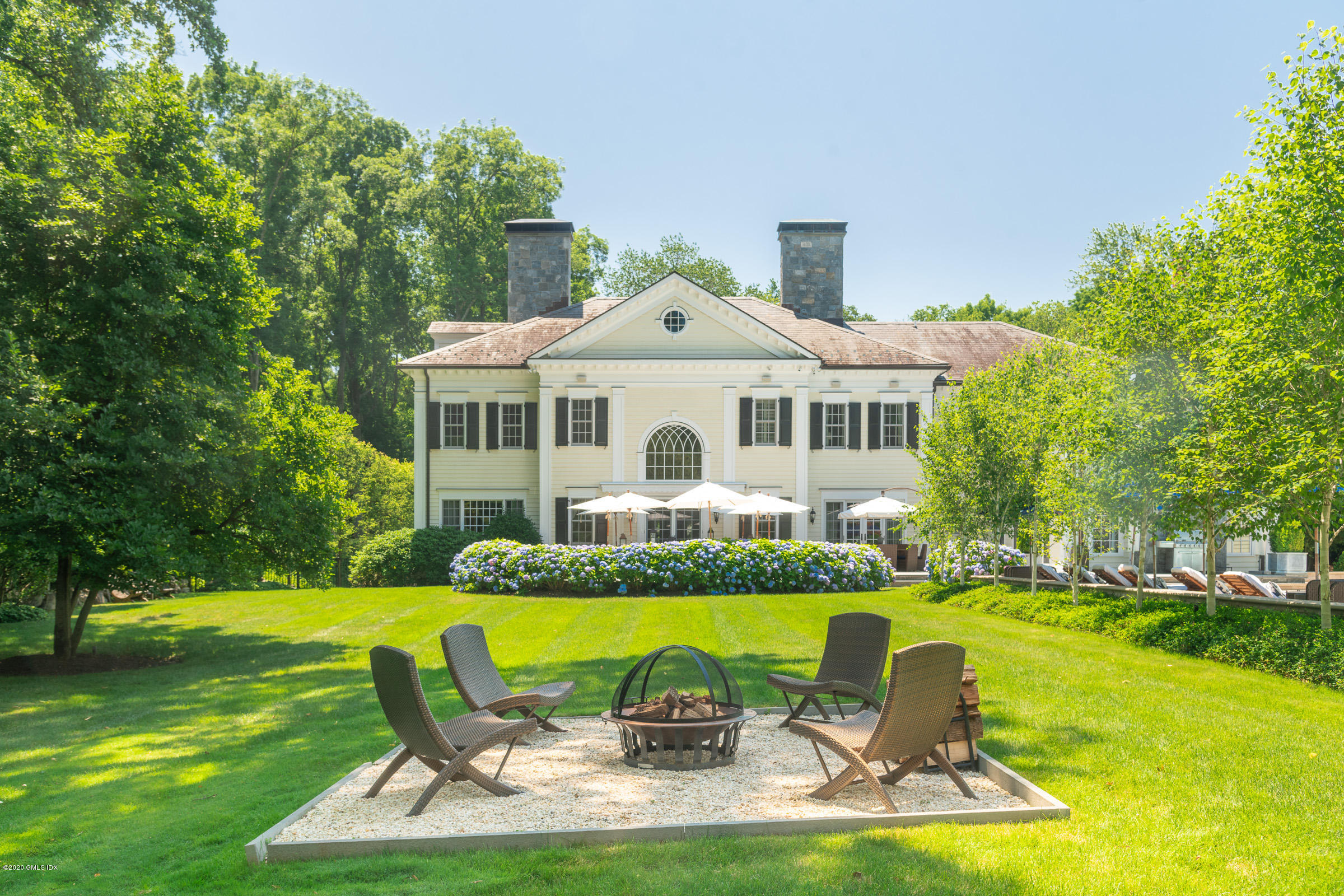 55 Perkins Road Greenwich, CT 06830 - Photo 33 of 38 a front view of house with swimming pool and green space