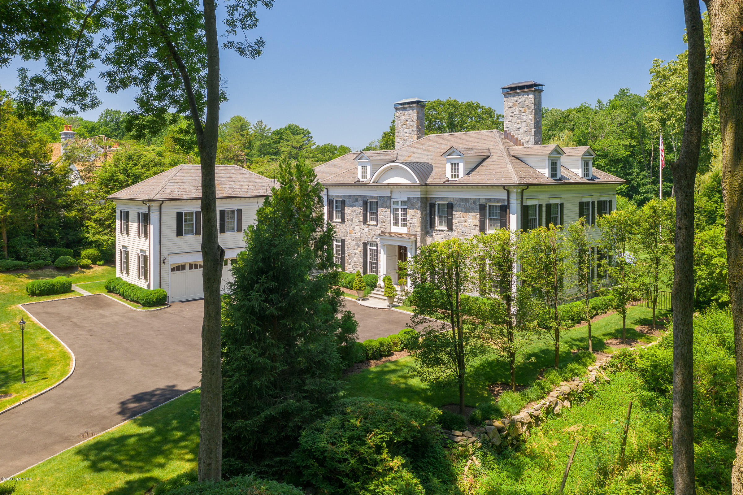 55 Perkins Road Greenwich, CT 06830 - Photo 4 of 38 a front view of a house with a yard