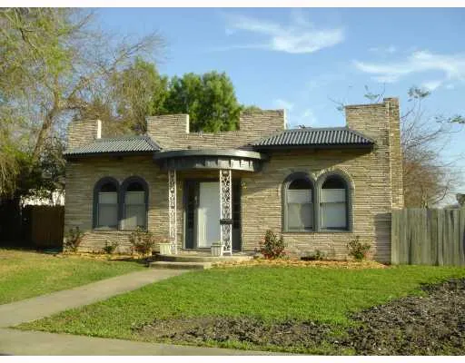 a view of a brick house with a yard