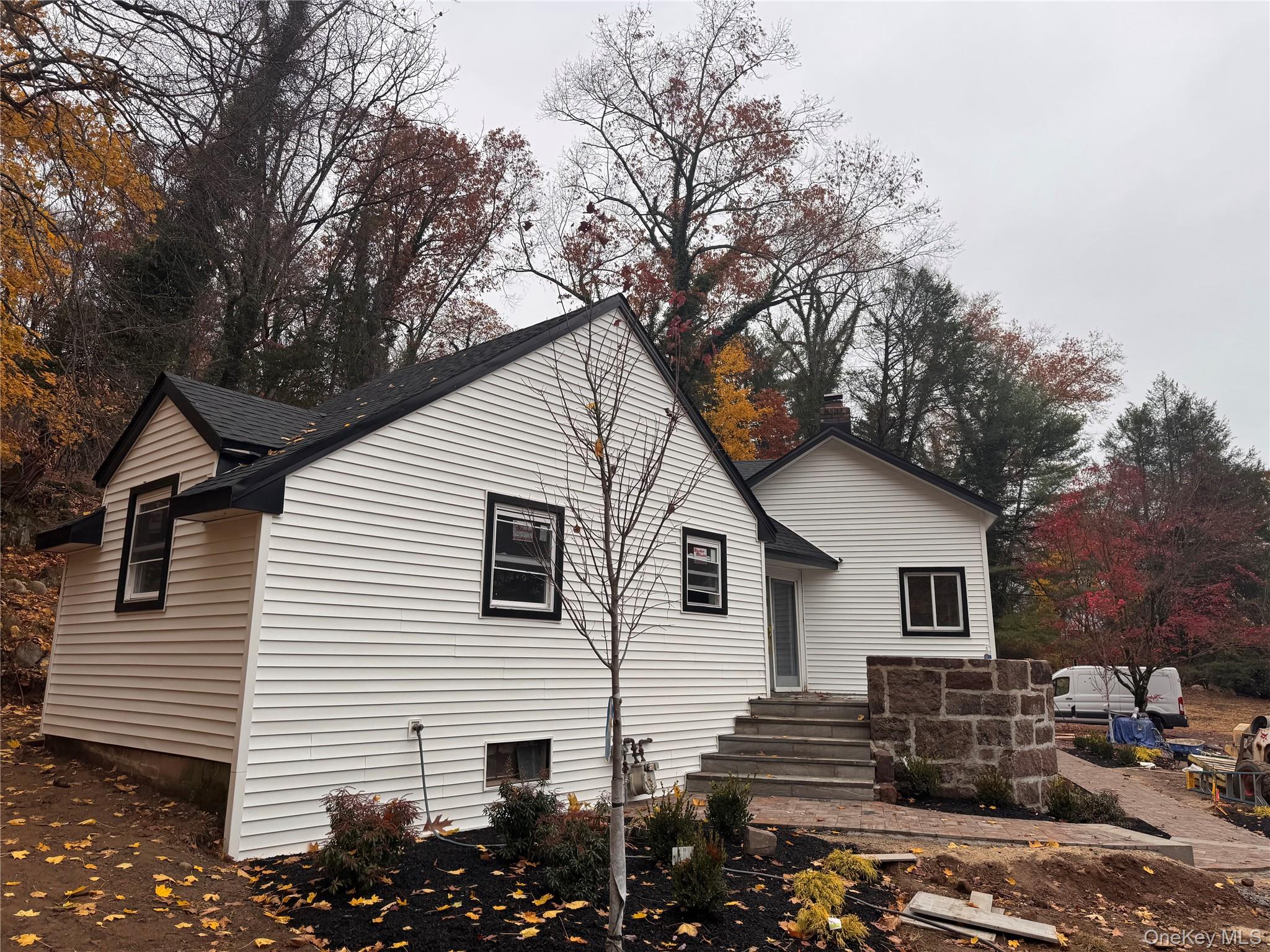 263 South Mountain Road New City, NY 10956 - Photo 1 of 33 Rear view of house with roof with shingles and view of wooded area