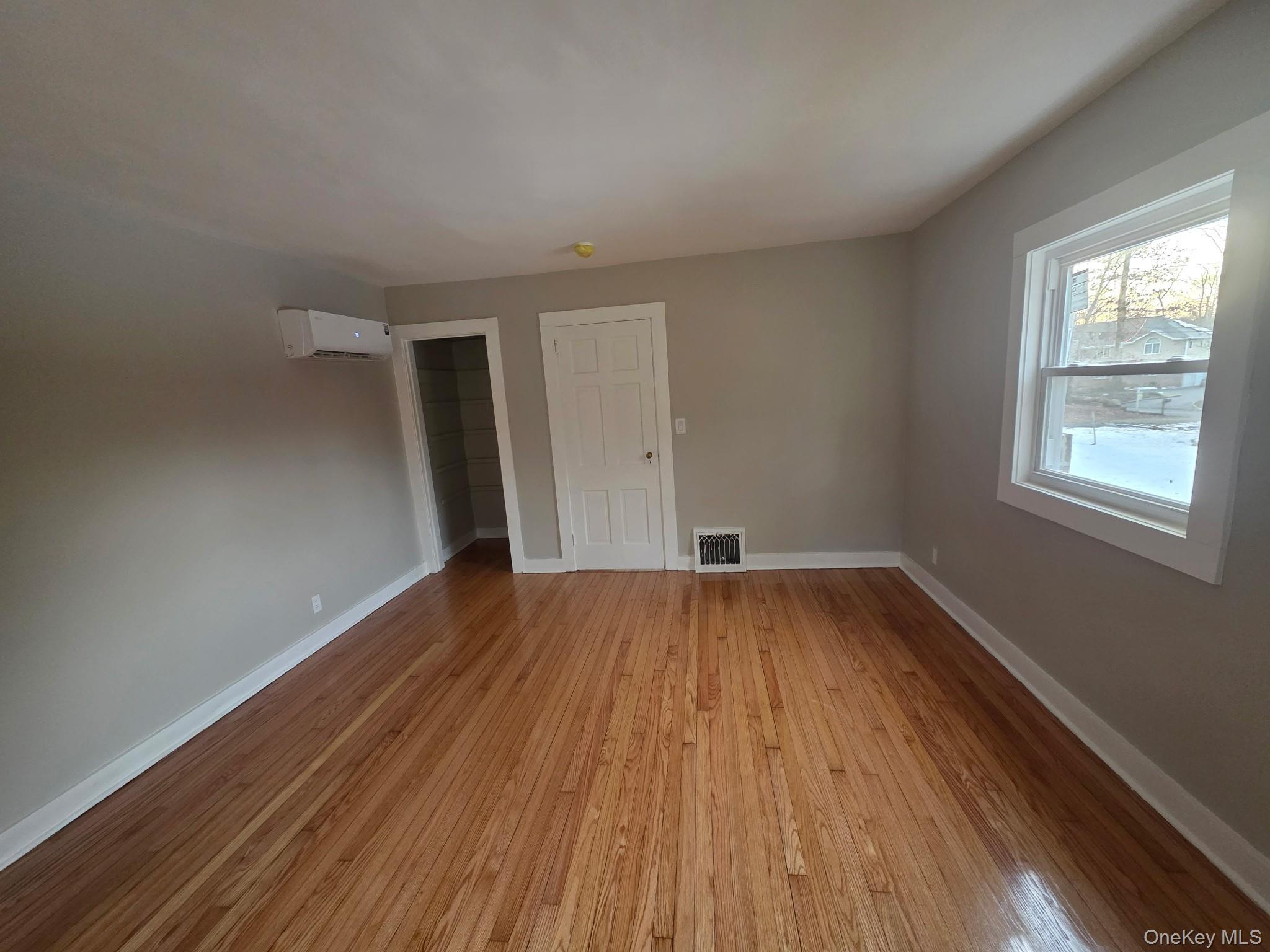 263 South Mountain Road New City, NY 10956 - Photo 20 of 33 Empty room with light wood-style floors and a wall unit AC