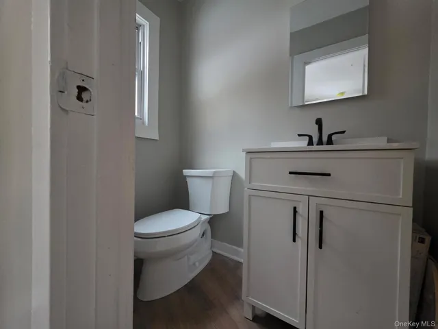 a view of bathroom with a sink toilet and mirror