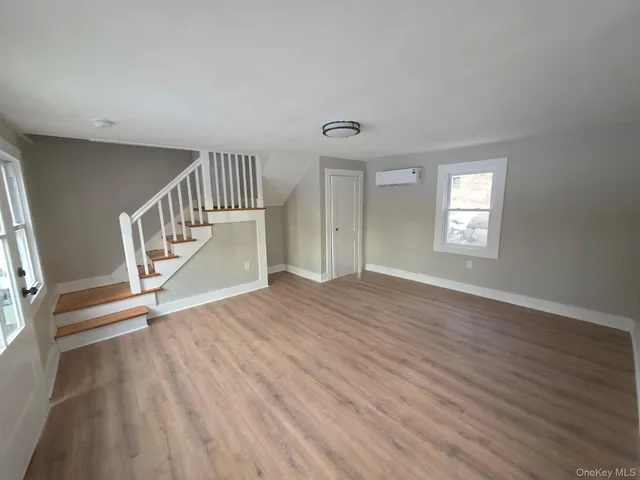 a view of an entryway with wooden floor
