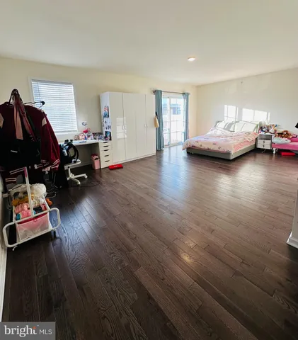a bedroom with furniture and a wooden floor