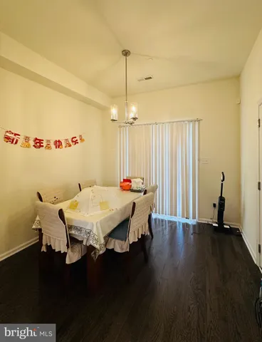 a dining room with a table chairs and a wooden floor