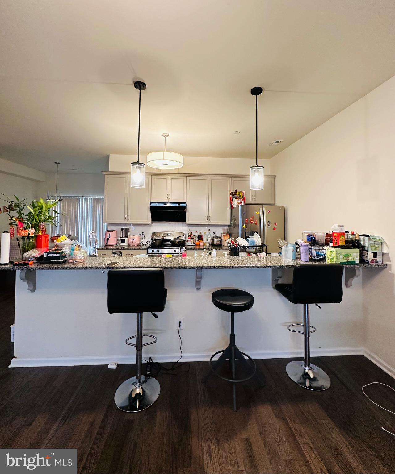 3408 Pietro Way Philadelphia, PA 19145 - Photo 7 of 21 a kitchen with stainless steel appliances kitchen island granite countertop a table and chairs in it