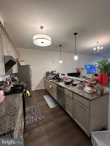 a kitchen that has a lot of cabinets a sink and a stove in it